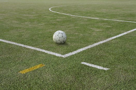 Soccer ball on sports field at boundary line