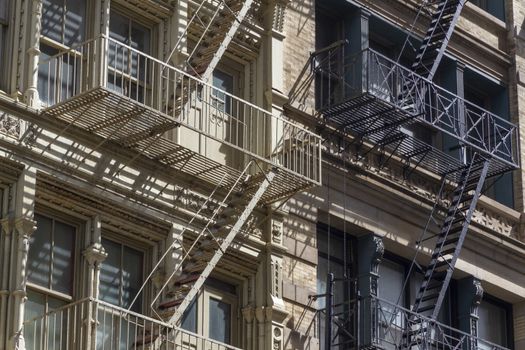 New York Fire escape stairs-downtown back alley architecture-steel and red brick background