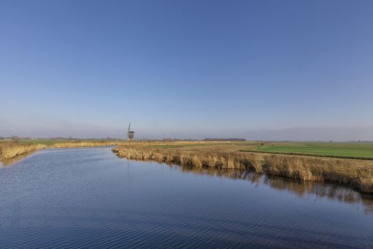 Windmill the Achterlandse molen near the Dutch village Groot-Ammers in the region Alblasserwaard - Image