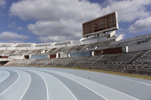 Blue sport track for running on stadium with tribune. Running healthy lifestyle concept. Sports background abstract texture