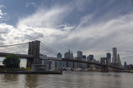 New York. View of Lower Manhattan and Brooklyn Bridge skyline on a sunny summer day from Brooklyn's side of East River