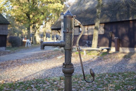Old vintage metal water pump in the garden of a old village in the netherlands - Image