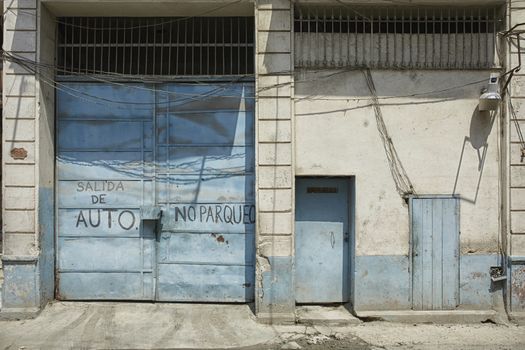 Blue rundown Garage door in Havana, Cuba