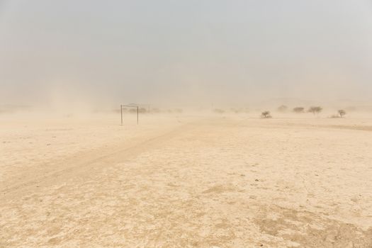 desert Soccer field in front of a white sand storm, Namibia, Africa