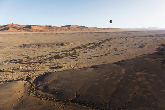 Colorful hot-air balloon flying over the high mountains in Namibia. High altitude. ( Namibia, South Africa)