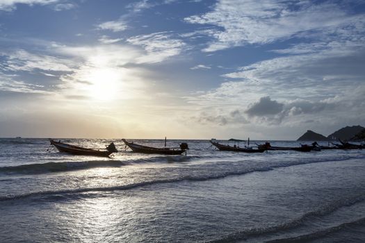 amazing cloudy sky on sunset at tropical island in Indian Ocean. Fishing boats with Beautiful and romantic sunset. Koh Tao popular tourist destination in Thailand.
