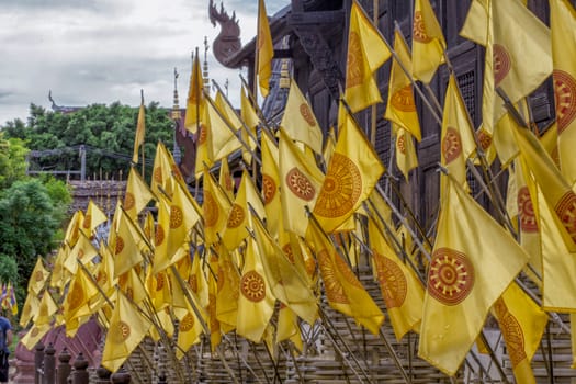 Buddhist flags at a temple in Chiang Mai, Thailand. The Symbol on the flags is religion logo not commercial one