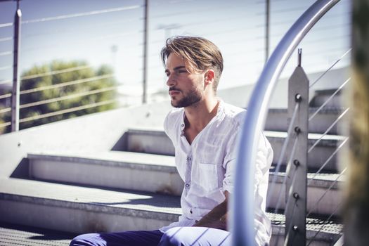 One handsome young man in urban setting in European city