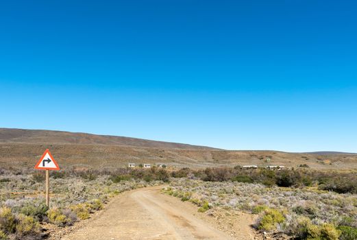 A landscape, with road sign and farm buildings, on road R356 to Ceres in the Western Cape Province