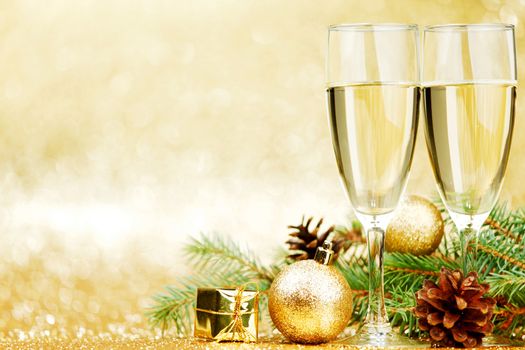 Champagne and new year decorations on golden background