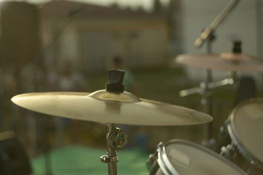 View of a drums, musical instrument, from the point of view of the player, shot in a stage ready for a live concert of a rock band.