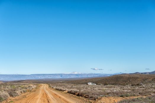 A farm landscape, with farm house, on road R356 to Ceres in the Western Cape Province. Snow is visible on Sneeuberg in the Cederberg