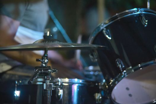 View of a drums, musical instrument, from the point of view of the player, shot in a stage ready for a live concert of a rock band.