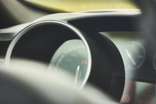 Count miles, speedometer, of an Italian car with warning light on. Illustrative detail.