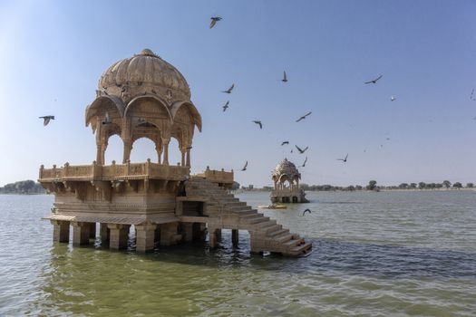 Artistically carved temples and shrines around The Lake Gadisar Jaisalmer.