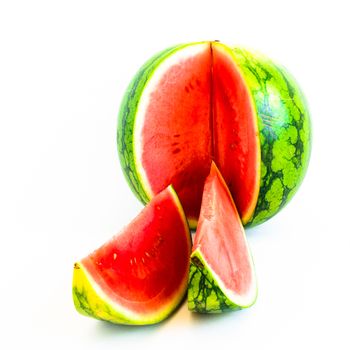 Cutout watermelon with slice cuts isolated on white background. Whole mini watermelon and cutout with clipping path and copy space.