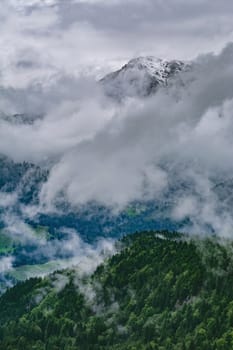 Snowy Peak of Mountain Range in Clouds