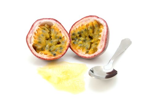 Passion fruit cut in half with juicy pulp and seeds, ready to eat with a spoon, on a white background