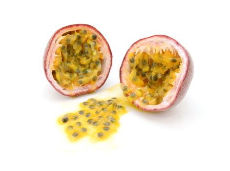 Passion fruit cut in half with juicy yellow pulp and seeds, on a white background