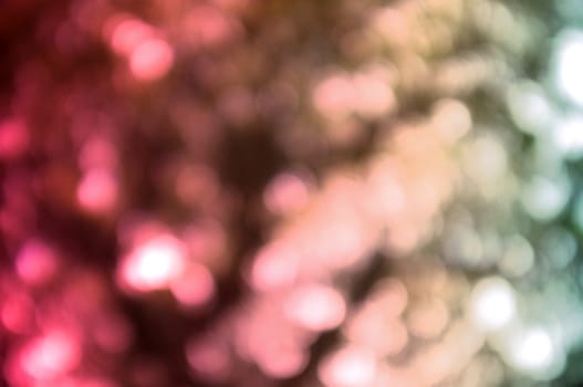 Colorful background with natural bokeh texture and defocused sparkling lights. 