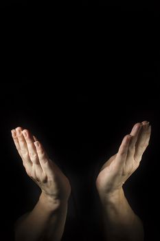 Female hands in prayer on a black background