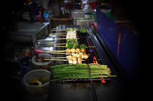 Asian street food Grilled with Chinese Sichuan Peppers (Ma-la) style , Seller prepare for meals, balls, seafoods and vegetables grill with Sichuan pepper.Thai Street food