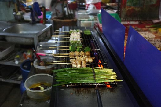 Asian street food Grilled with Chinese Sichuan Peppers (Ma-la) style , Seller prepare for meals, balls, seafoods and vegetables grill with Sichuan pepper.Thai Street food