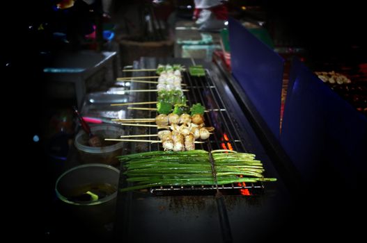 Asian street food Grilled with Chinese Sichuan Peppers (Ma-la) style , Seller prepare for meals, balls, seafoods and vegetables grill with Sichuan pepper.Thai Street food