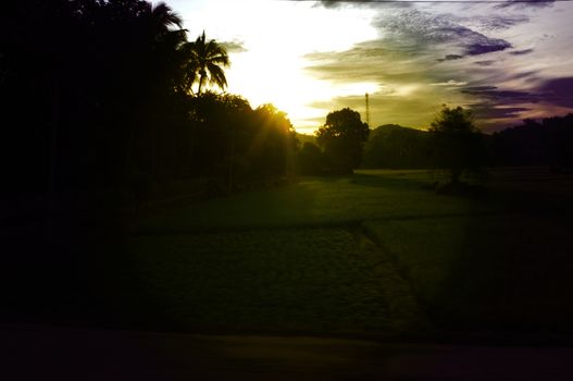 A colorful sunup above a small train station in thailand , Effect lens flare