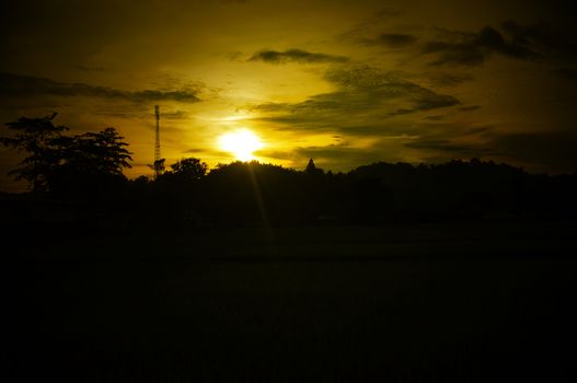 A colorful sunup above a small train station in thailand , Effect Golden light