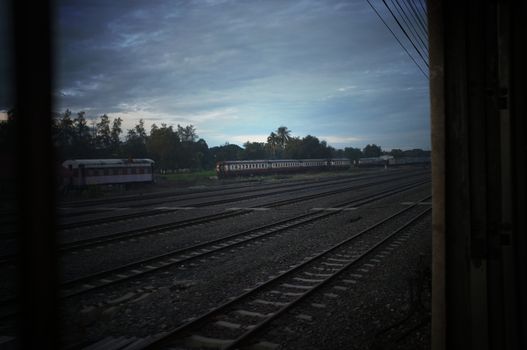 A colorful sunup above a small train station in thailand 