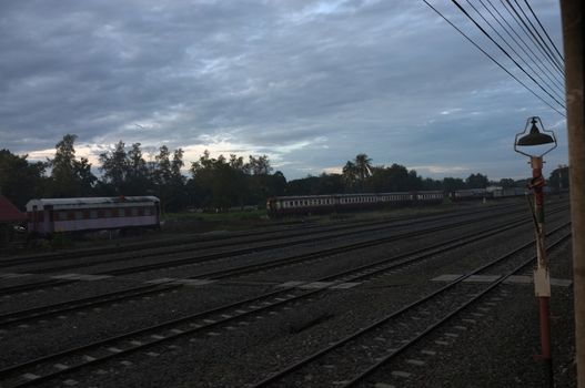 A colorful sunup above a small train station in thailand 