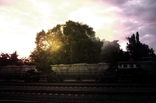 A colorful sunup above a small train station in thailand 