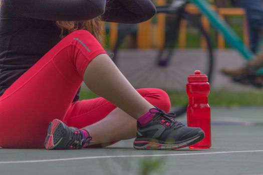 Woman adjusting her tennis shoes before running