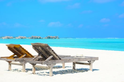 lounge chairs on a beautiful tropical beach at Maldives