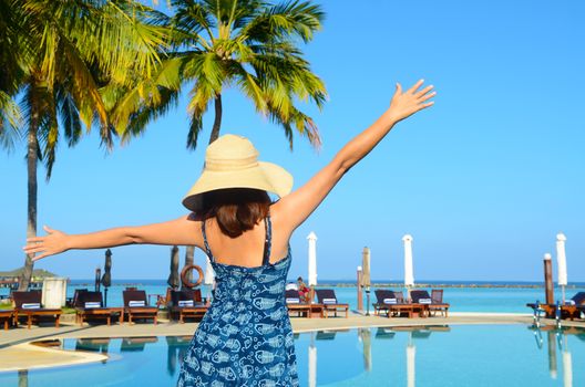 Beautiful asian young woman in sunhat relaxed at tropical beach in Maldives