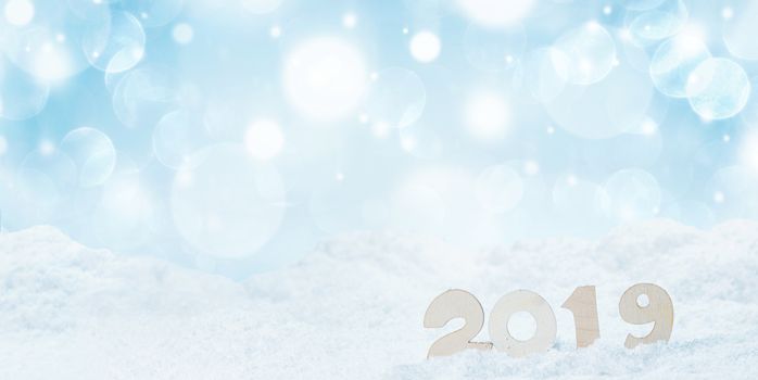 2020 New Year in snow design concept. Wooden 2020 New Year horizontal template with blue and white bokeh backgound
