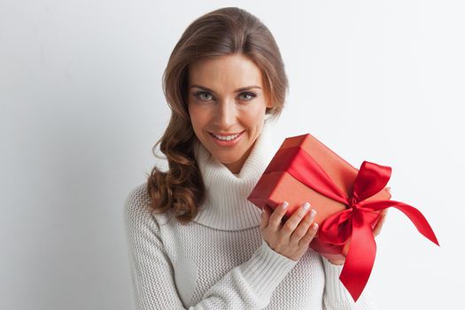 Smiling cute girl with red christmas gift box