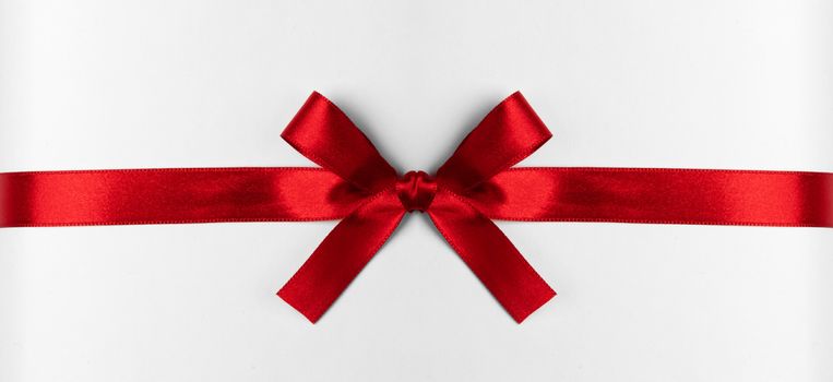Red gift bow isolated on white background