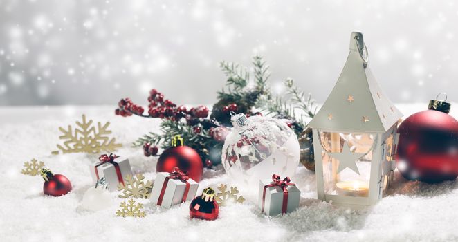 Christmas holidays card with gifts , balls and glowing lantern in snow