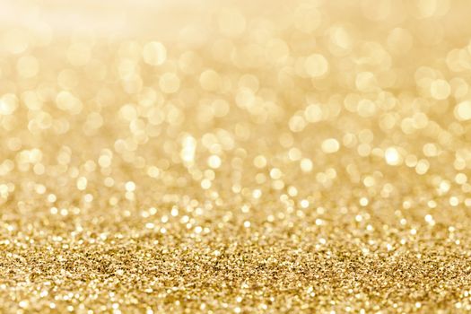 Shiny golden bokeh glitter lights abstract background, Christmas New Year party celebration concept