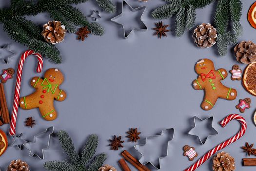 Christmas food frame. Gingerbread cookies, spices and decorations on gray background with copy space