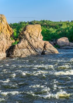 The rocky banks of the Southern Bug River near the village of Migiya in Ukraine on a sunny summer day