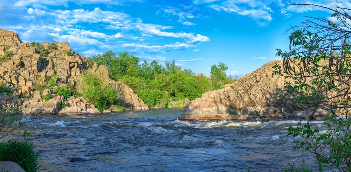 The rocky banks of the Southern Bug River near the village of Migiya in Ukraine on a sunny summer day