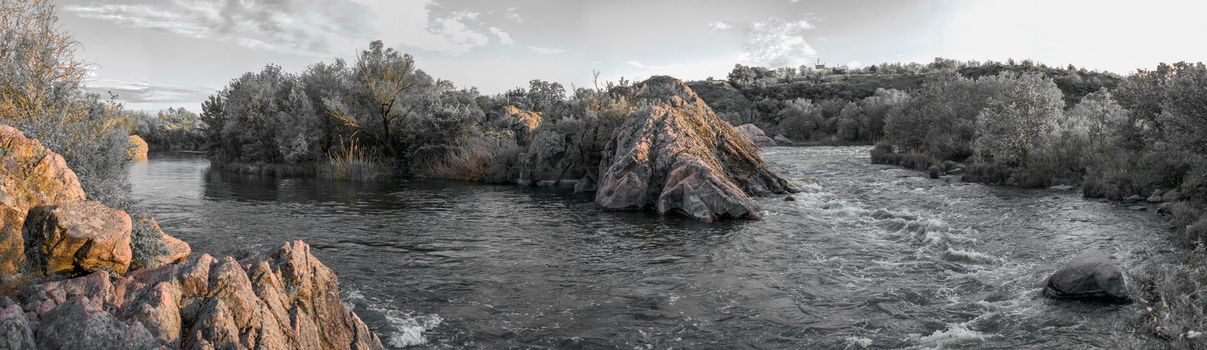 The rocky banks of the Southern Bug River near the village of Migiya in Ukraine on a sunny summer day