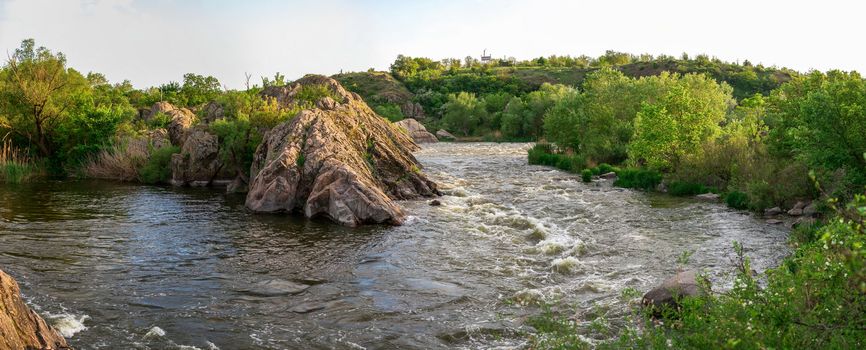 The rocky banks of the Southern Bug River near the village of Migiya in Ukraine on a sunny summer day