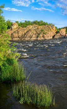 The rocky banks of the Southern Bug River near the village of Migiya in Ukraine on a sunny summer day