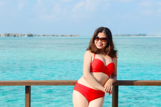 Portrait of happy woman at beautiful  villa at Maldives island. Travel and Vacation. 