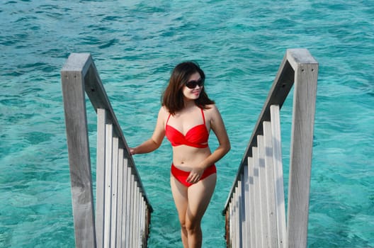 Portrait of happy woman at beautiful  villa at Maldives island. Travel and Vacation. 