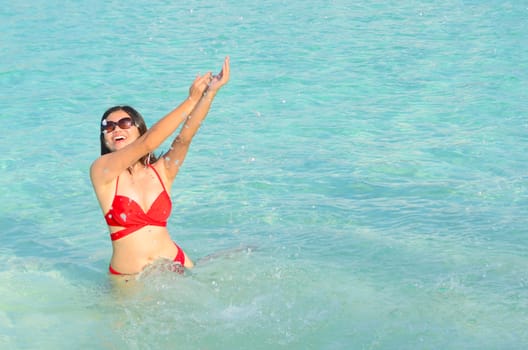 Woman swim and relax in the crystal-blue sea of tropical beach at  Maldives islands. Happy lifestyle concept. 